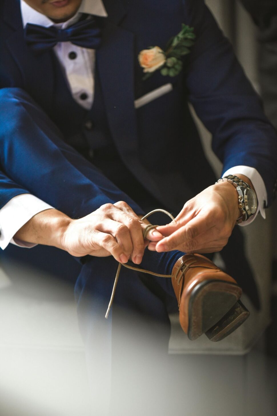 https://www.pexels.com/photo/person-tying-shoelaces-1566421/