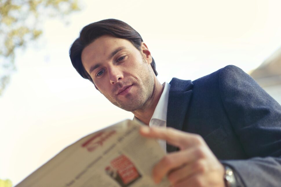 https://www.pexels.com/photo/low-angle-shot-of-man-reading-newspaper-760118/