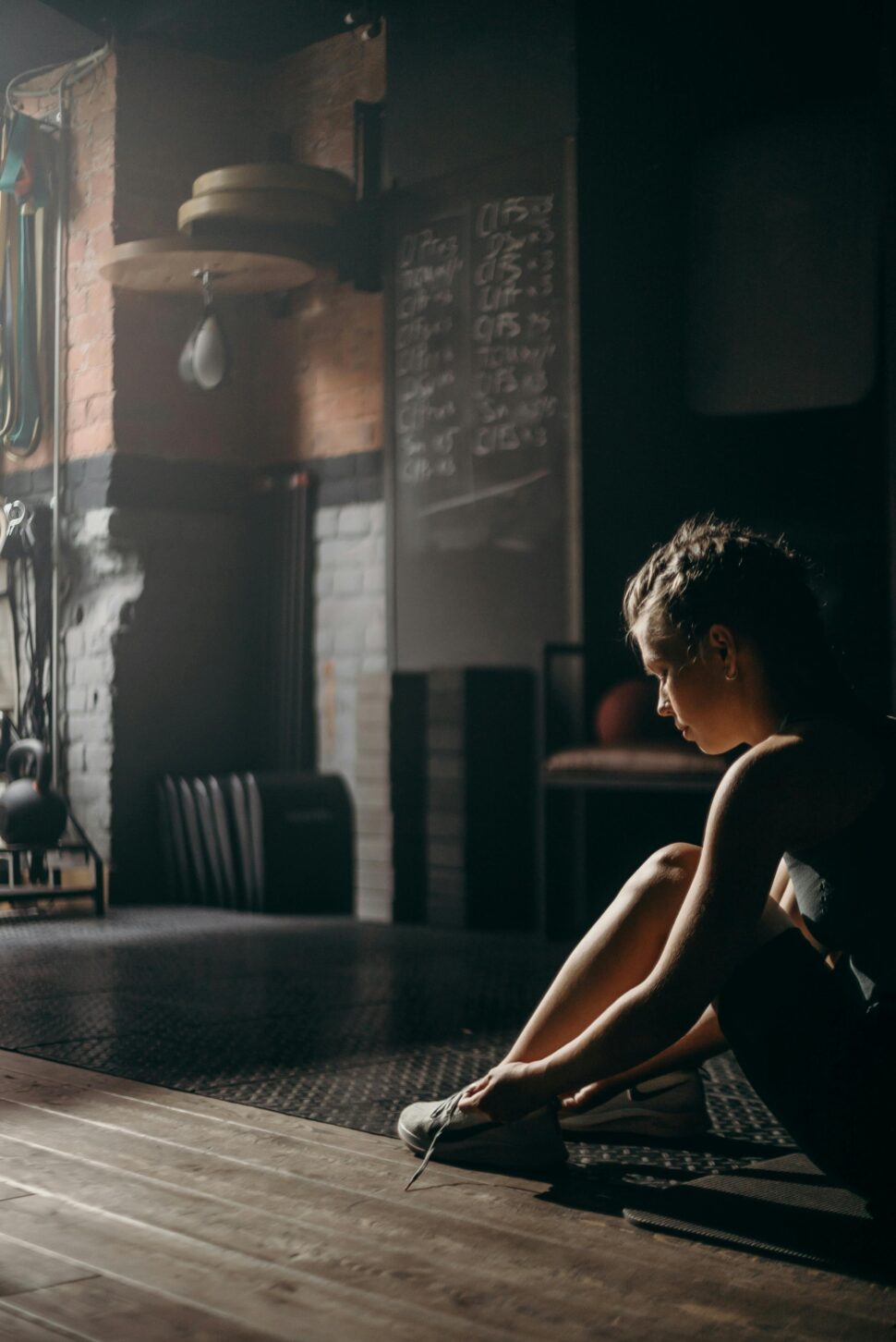 https://www.pexels.com/photo/woman-in-black-tank-top-sitting-on-chair-4753983/