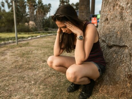 https://www.pexels.com/photo/photo-of-a-woman-crouching-while-her-hands-are-on-her-head-5542968/