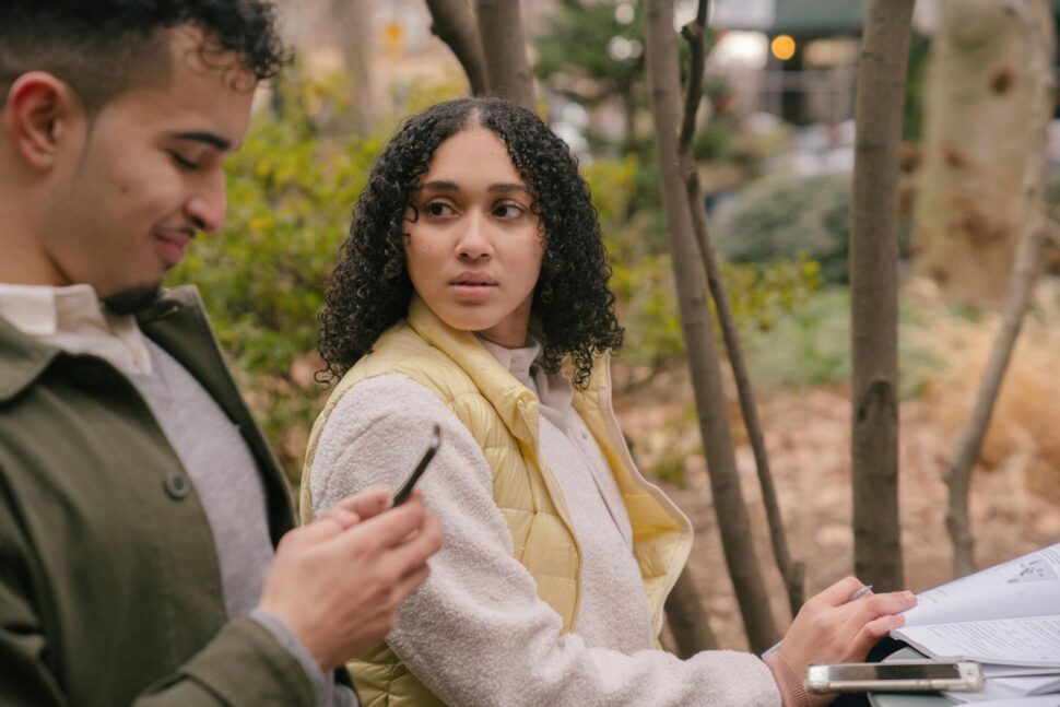 https://www.pexels.com/photo/latin-american-couple-at-table-with-textbooks-with-smartphones-6532612/